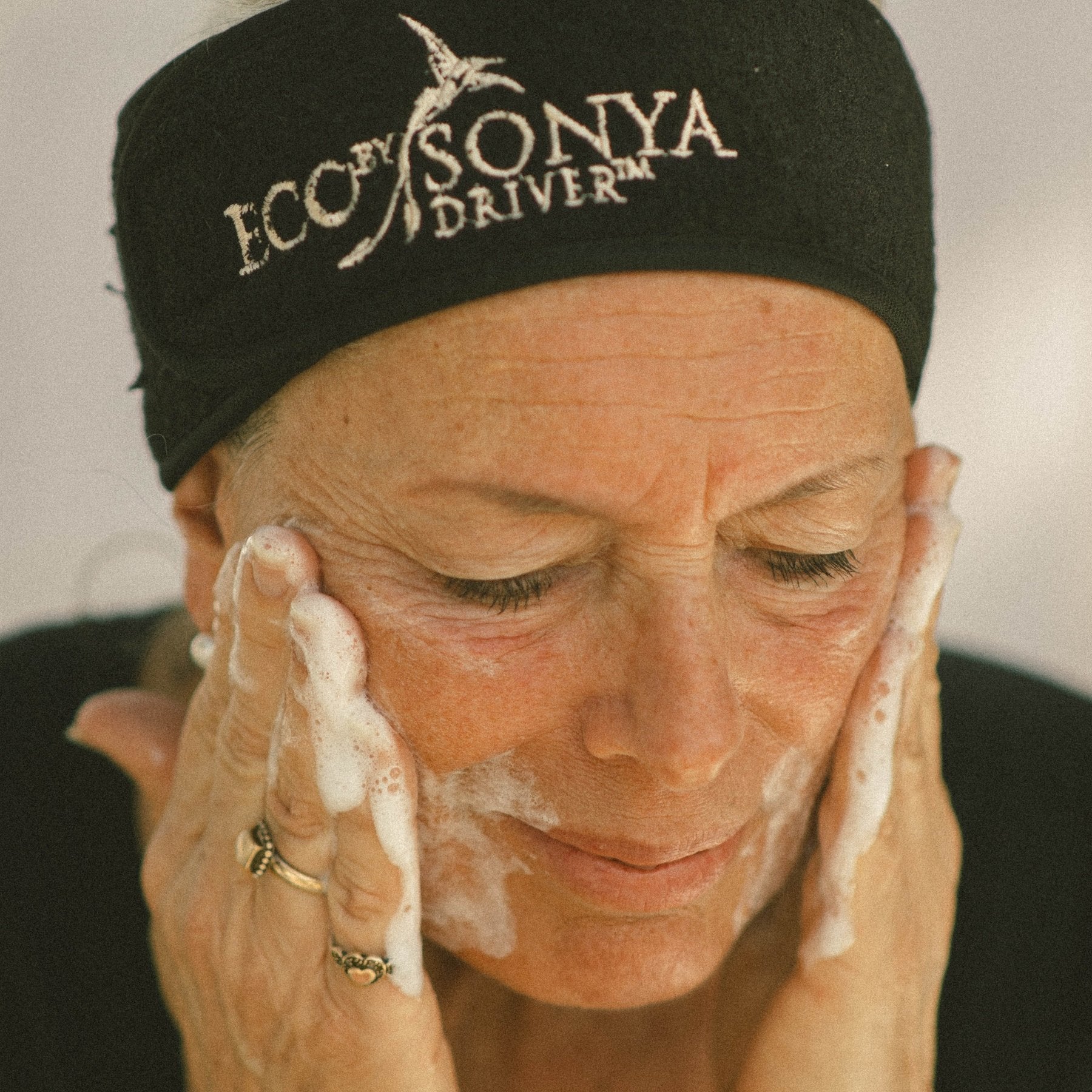 Mature skincare applying Super Citrus Cleanser on face
